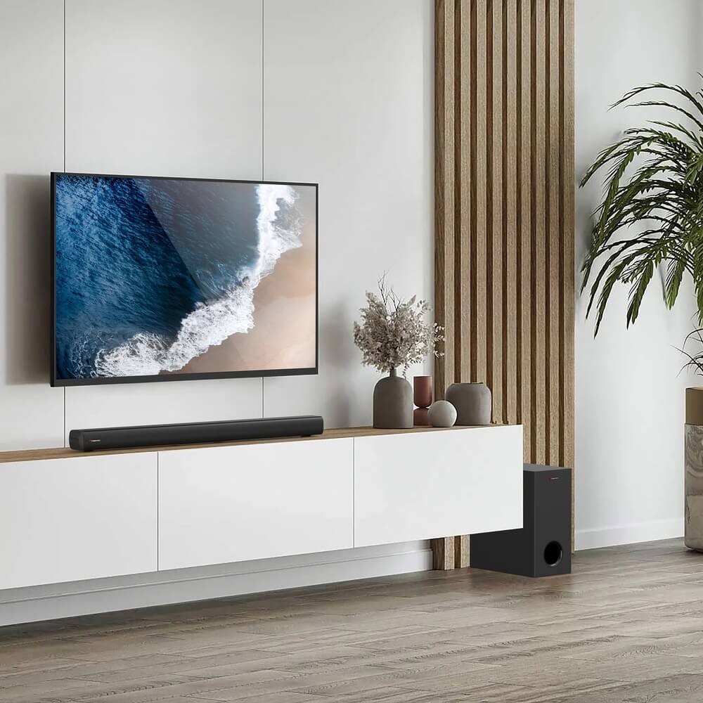 Nakamichi ARES 210 в интерьере гостиной рядом с телевизором на стене